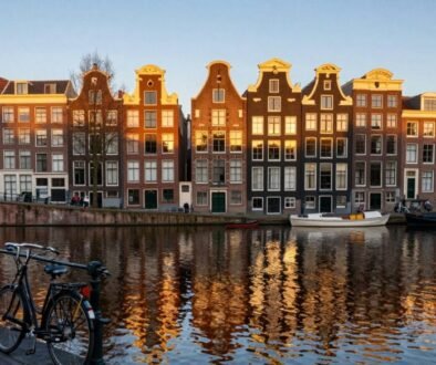 Amsterdam Canal Belt with historic houses reflecting in the water during golden hour